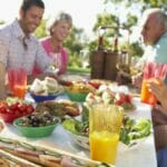 family enjoy lunch in garden 800